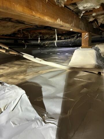 Installed Crawl Space Vapor Barrier Beneath Wood Framing
