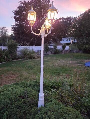 After: Beautifully refinished outdoor lantern post post-restoration.