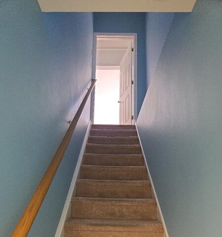 After: Brightly transformed stairwell painted in crisp sky blue to match the remodeled basement.