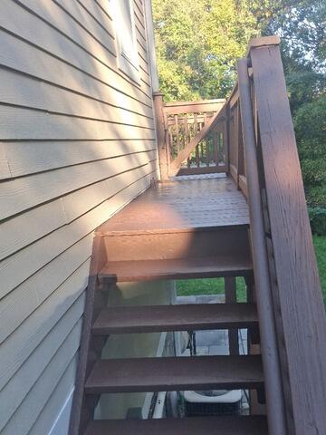 Fully restored deck stairs finished with a uniform, premium dark brown stain.