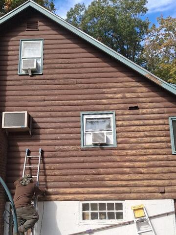 Meticulous hand-scraping and sanding on high gables to ensure superior primer adhesion.