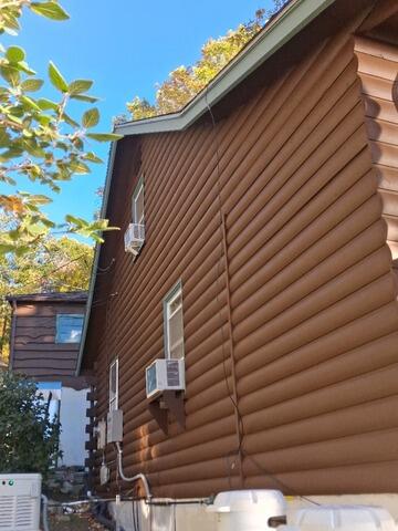 Beautifully restored and freshly sealed log siding showcasing a uniform, rich wood finish and complete weatherproofing protection