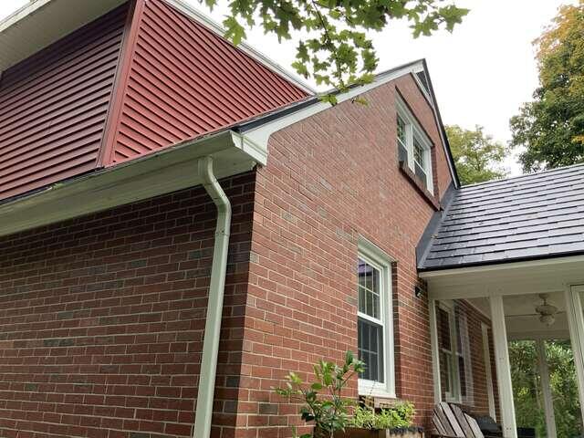 Exterior Pipe Routing Along the Brick Home