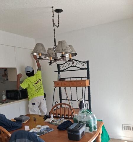 Precision painting around custom cabinetry, light fixtures, and delicate interior trim