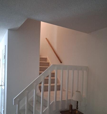 Flawless white paint application on interior stair railings and high-traffic entryways