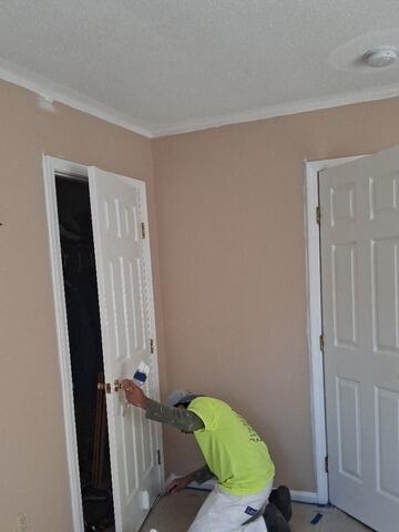 Detailed hand-painting and trim refinishing on interior doors and frames