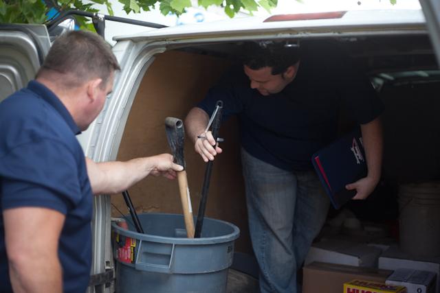 Jack and Juan look at the back of each service truck to ensure all tools are properly stored and cleaned.
