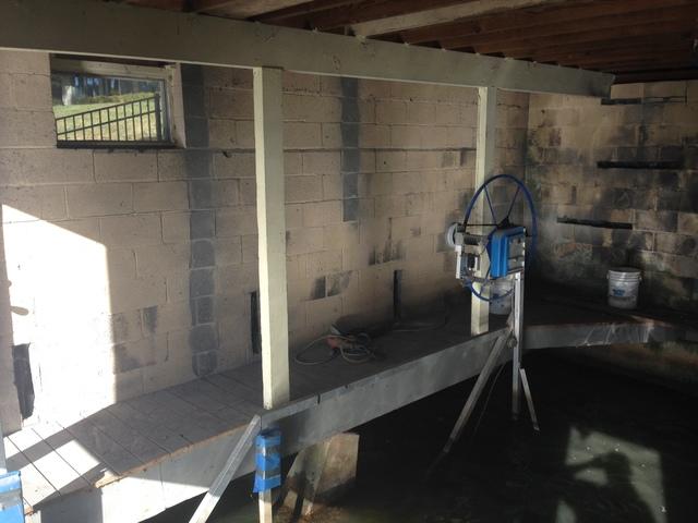 <p>This is an image of the boathouse before all of our repairs were completed. You can see that it needed structural repairs to stop the walls from bowing and cracking.</p>