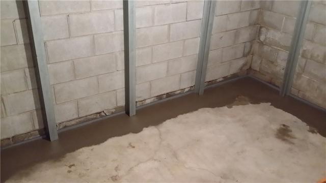 Eleven PowerBraces were installed on the affected walls. The braces provide support to the wall structure to prevent it from cracking further or, worse yet, caving in. Also shown, the result of the WaterGuard installation after new concrete is poured to restore the floor.