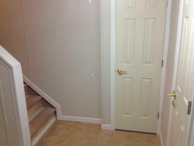 This picture shows the finished stair case as well as the Thermal Dry- Caynon Beige Tile Flooring in this Albany, NY home.