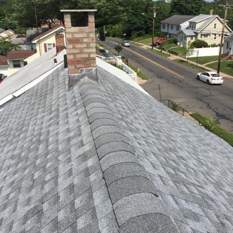 <p>We were able to renovate the ridge of this roof. The newly re-painted chimney puts the high quality finishing touches on this roof.</p>