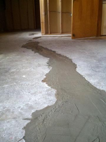 <p>Customer called to have massive heaving floor crack "filled in" per home inspector report.&nbsp; She was told that some caulking material would do the trick.&nbsp; The floor was heaved and unlevel throughout.&nbsp; We cut the bad areas out which was up to 8 inches in spots.&nbsp; The efflorescence was treated and the crack was filled with self leveling vinyl patch concrete.</p>