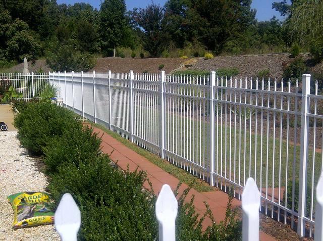 White Aluminum fencing catches the eye in a way that is unique to traditional ornate fencing.