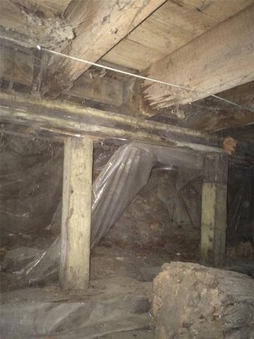 Rotting Wooden Beams and Support Posts in Collapsing Crawl Space