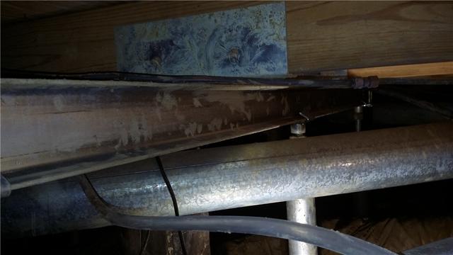 Steel beams were installed throughout the crawl space to reinforce and stabilize the existing wooden beams.