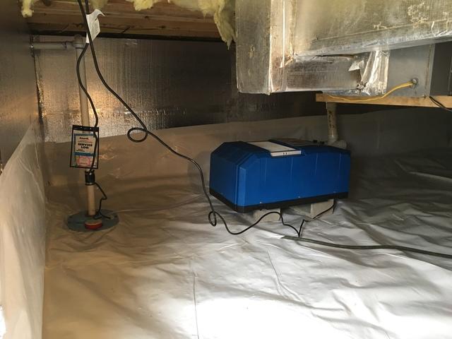 In this image you can see the SaniDry CX dehumidifier unit tied seamlessly into our SuperSump unit. Not only will water that tries to enter the crawl space be pumped out, but the moisture in the air will also be controlled.