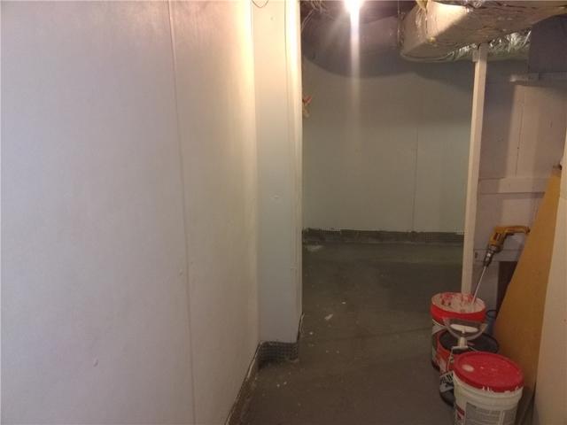 <p>The installation crew attached BrightWall rigid plastic paneling in the basement.</p>