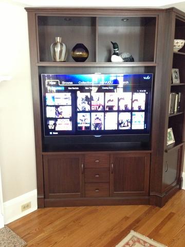 TV cabinet full size with LED flatscreen and speaker bar.