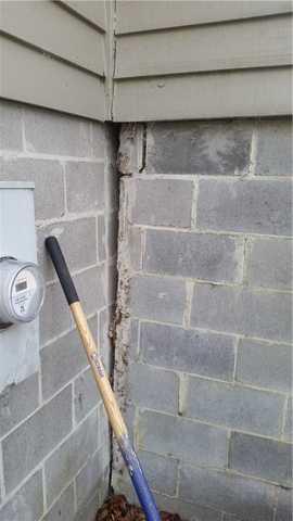 The chimney falling away from the home