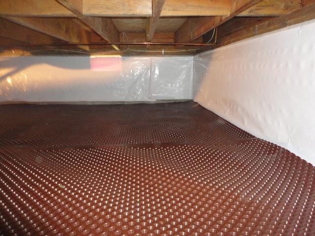 <p>The drainage matting was installed before the vapor barrier went on the ground.</p>