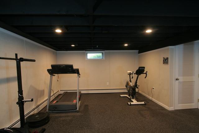 This part of the basement was transformed into a home gym! Its great because you have space for several different machines, as well as an open area for circuit training, or even a little bit of yoga!