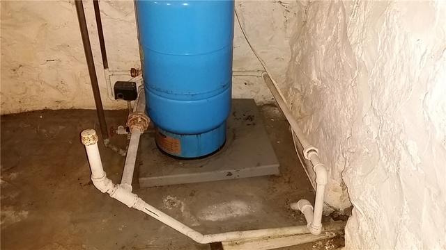 The hot water heater was known to overflow, adding to the ambient moisture problems in the basement. We installed a Flood Ring to keep the water contained and direct it to the WaterGuard.