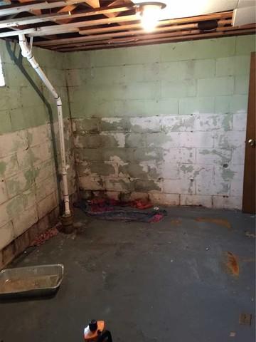 Severe Water Damage and Mold in Basement Corner