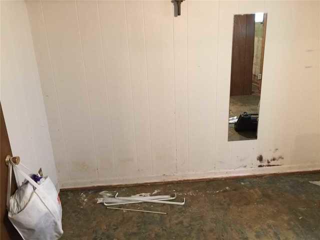 Even the finished parts of the basement aren't safe from water and mold. Note the warping on the lower parts of the panels, and the obvious mold.