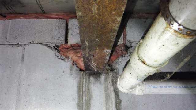 Water Damaged Wooden Beam in Basement