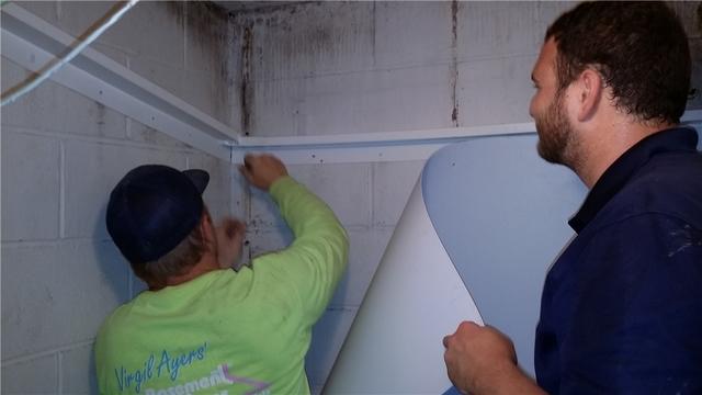 Project Manager Nick shows our new Service Tech JT the ropes as he prepares the wall for Brightwall installation.