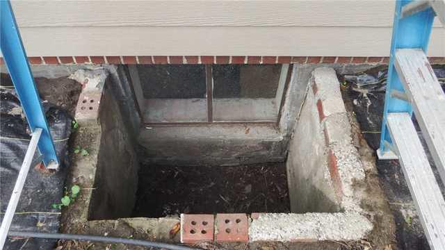 The fact that some portions of the concrete have already been replaced by bricks, which also seem to be falling apart, doesn't inspire much confidence. We also have the same gapping between the foundation and well and signs of other concrete patchwork.