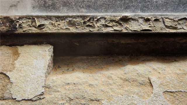 This is an obvious entry point for water. Either the window wasn't properly installed in the first place or the concrete has eroded with time. Either way, it has to go.