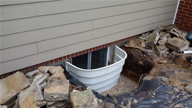 While the concrete was lovely, these window wells will be better both aesthetically and when it comes to waterproofing.