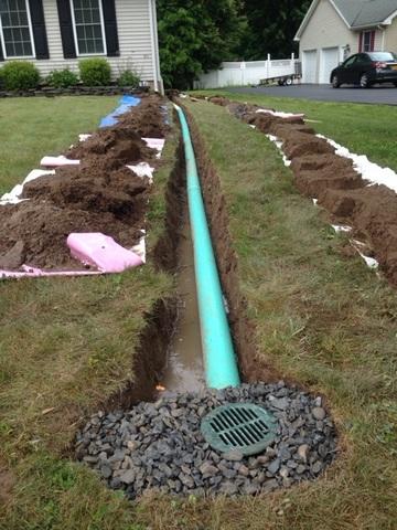 Our crew laid the pipe in the ditch. As they laid the pipe into the ditch they checked the pitch to make sure it was perfect. They also place gravel around the end of the discharge line which in this case was a bubbler pot.