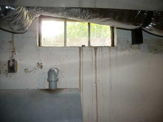 <p>The stains on the wall of this MD basement are clear evidence that the windows are leaking. Most basement windows are below ground and have a metal shroud around them that acts like a funnel for rain water and mud. This window is a little more at ground level, but still gets very leaky.</p>