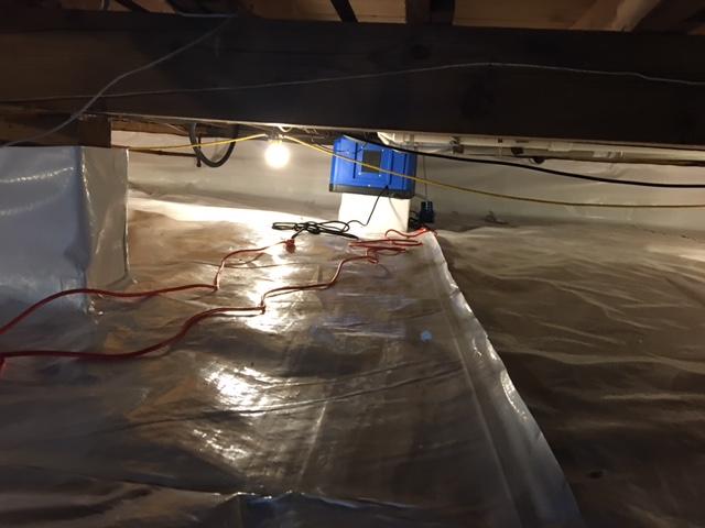 Near the back wall of the crawl space is a SaniDry CX. This is a dehumidifier system that is high efficiency and will self drain to outside of the house. Making things easy for the home owner!