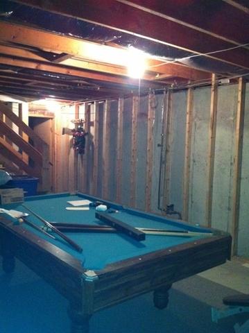 Unfinished basement with a pool table in Windsor, CT 