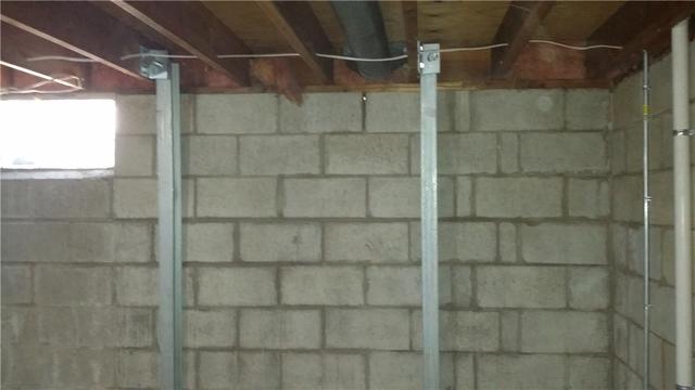 We secure PowerBraces to the concrete floor and the overhead support beams to ensure stability.