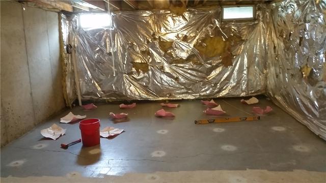 The basement is currently being injected with PolyLevel foam in this picture.