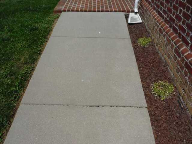 The sidewalk in Woolford, MD has cracks and sinking concrete.