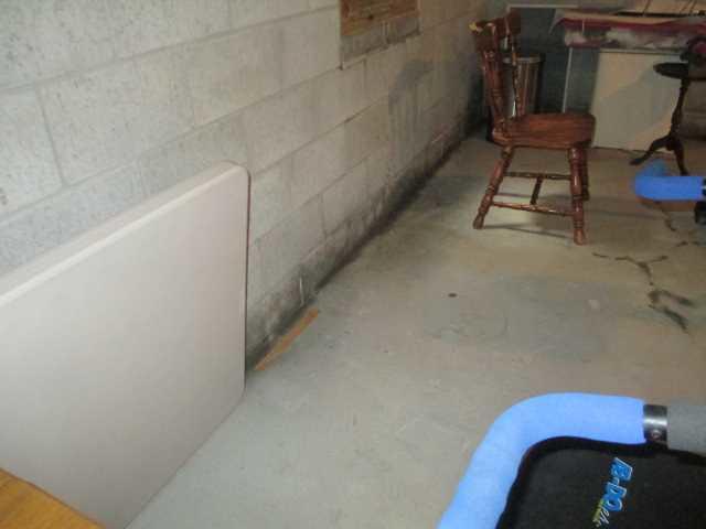 Heavy water damage is visible at the join of the wall and the floor - this is unsurprising since a lot of the water issues were originating in the floor. This is likely a result of soil shifting in the road work that was done a few years ago, and the resulting hydrostatic pressure.