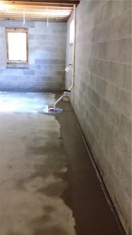 After everything is installed, new concrete is poured to restore the floor to its original state - that is, a floor - but better, since the flooding will be taken care of.