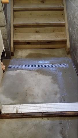 In spots where a lot of water invades in short order, like doorways and the base of stairs, we can install a TrenchDrain system. The large grates allow for quick draining and it's tied right into the WaterGuard for easy removal.