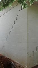 This foundation crack extended over 12 ft long and was down over 1 inch.