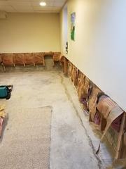 Alberto and Justin first made a horizontal cut at wainscot height, to remove the mold-damaged and mold-prone lower section of wood-framed basement walls. Moisture-damaged fiberglass insulation is also removed. Existing electrical wall outlets can usually remain in place.