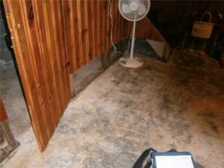 As you can see in this photo, the walls and floors in this basement were not pleasant. The floors were cold and the bottom of the walls were affected by moisture damage.