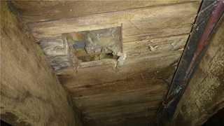 The plywood floor in our friend's cottage was in extremely rough shape. There were holes in the floor like this throughout the entire home.