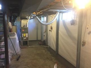 At the bottom of the wall, you can see where the WaterGuard drainage was installed. A layer of cement covers them, leaving a small wall flange exposed. The WaterGuard Port can also be used to drain dehumidifiers or condensation lines.