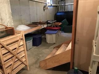 These unfinished stairs and exposed pipes made this basement uninviting and uncomfortable.
