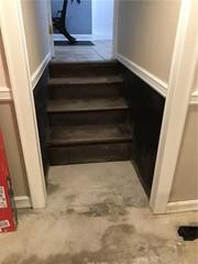 These stairs were once dark, and covered with scuff marks and scratches. Plus, a cold concrete floor makes for an uncomfortable basement environment.